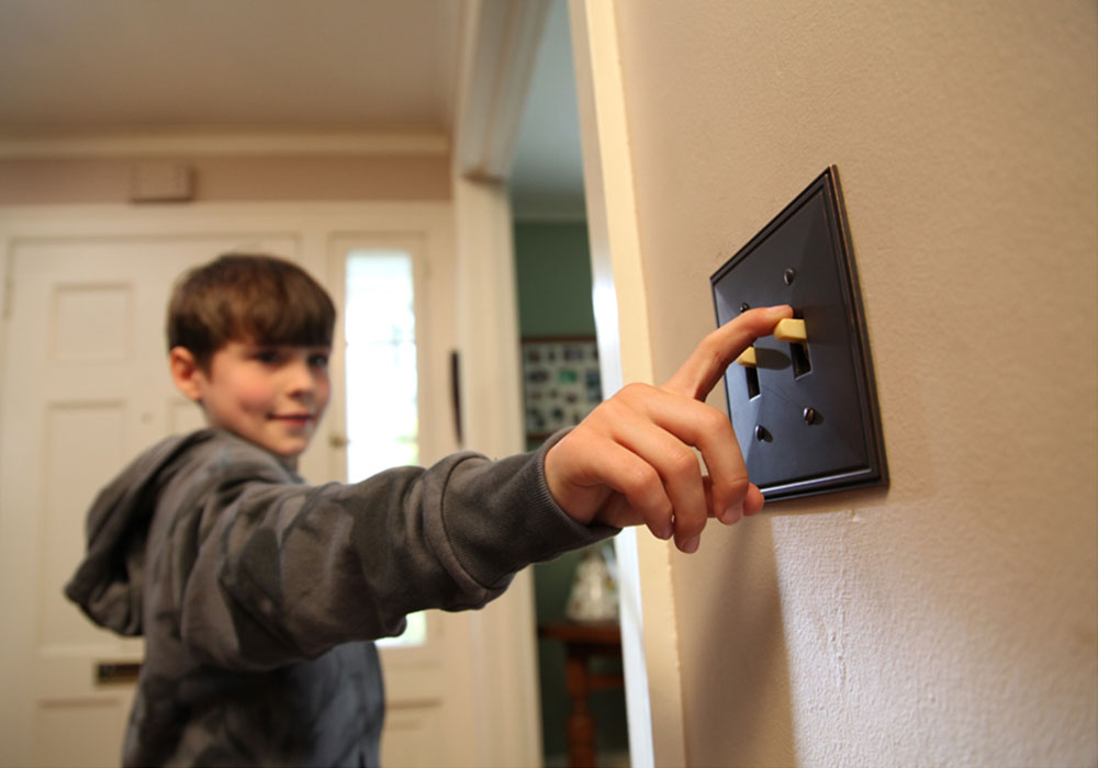 Boy flipping light switch