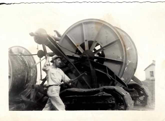 old photo of man using machine