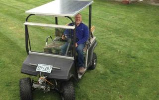 man in solar powered golf cart